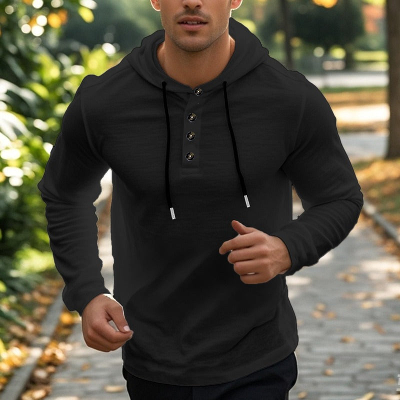 Men's henley hoodie with a button placket in black, worn, front view