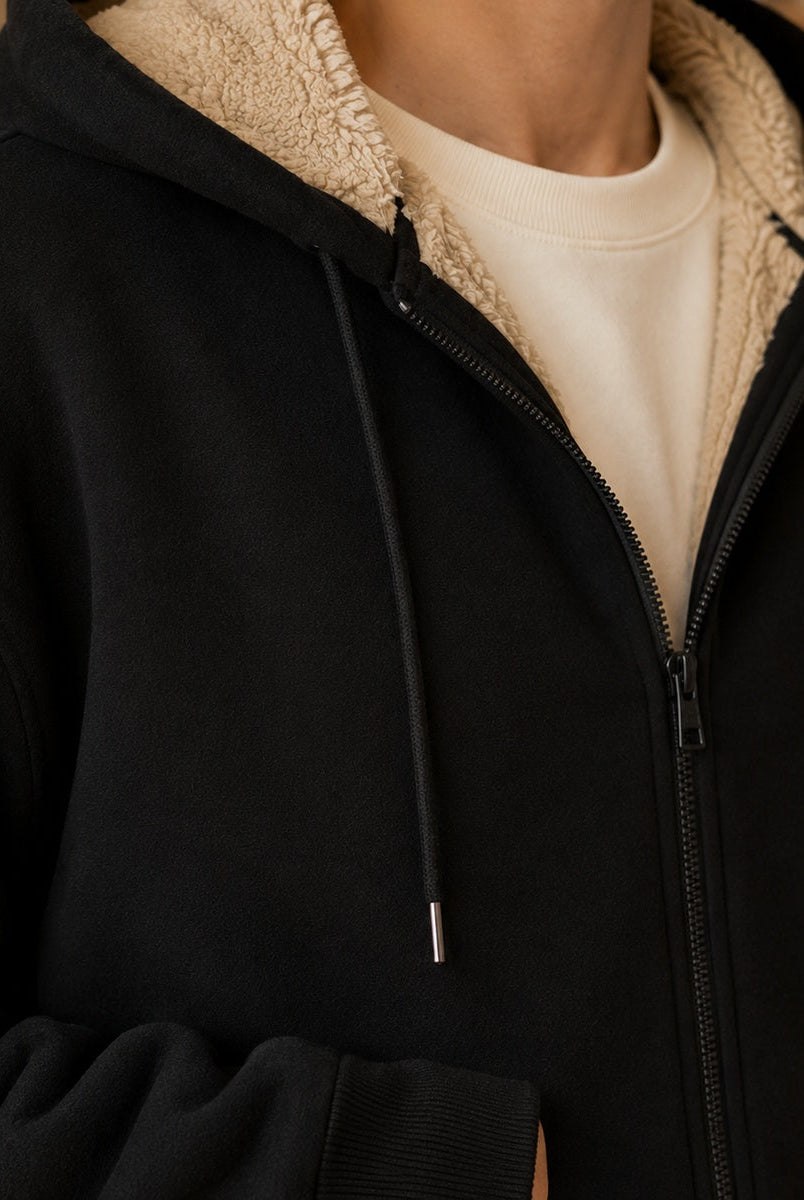 Men's zip-through hoodie in black, close-up of the sherpa-lined hood and the zip