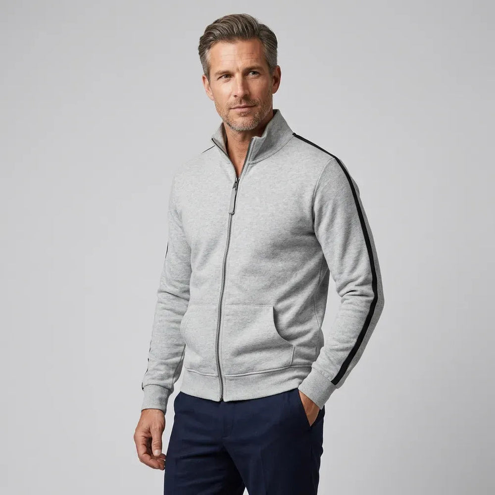 Man wearing a light grey zip-up sweatshirt with black sleeve stripes and navy trousers | Chaps London