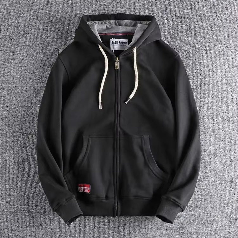 Black zip-up hoodie with a grey-lined hood and off-white drawcords, laid flat | Chaps London
