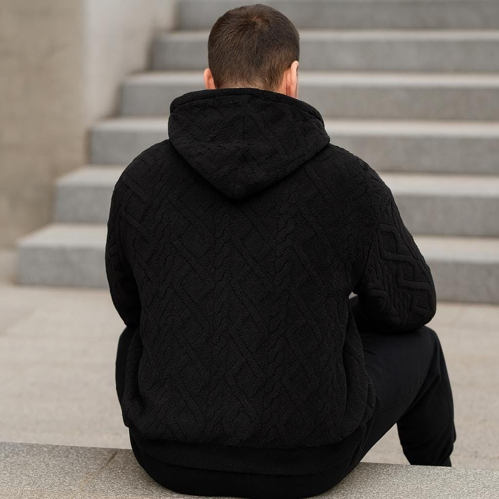 Men's quilted teddy fleece hoodie in black, worn, back view