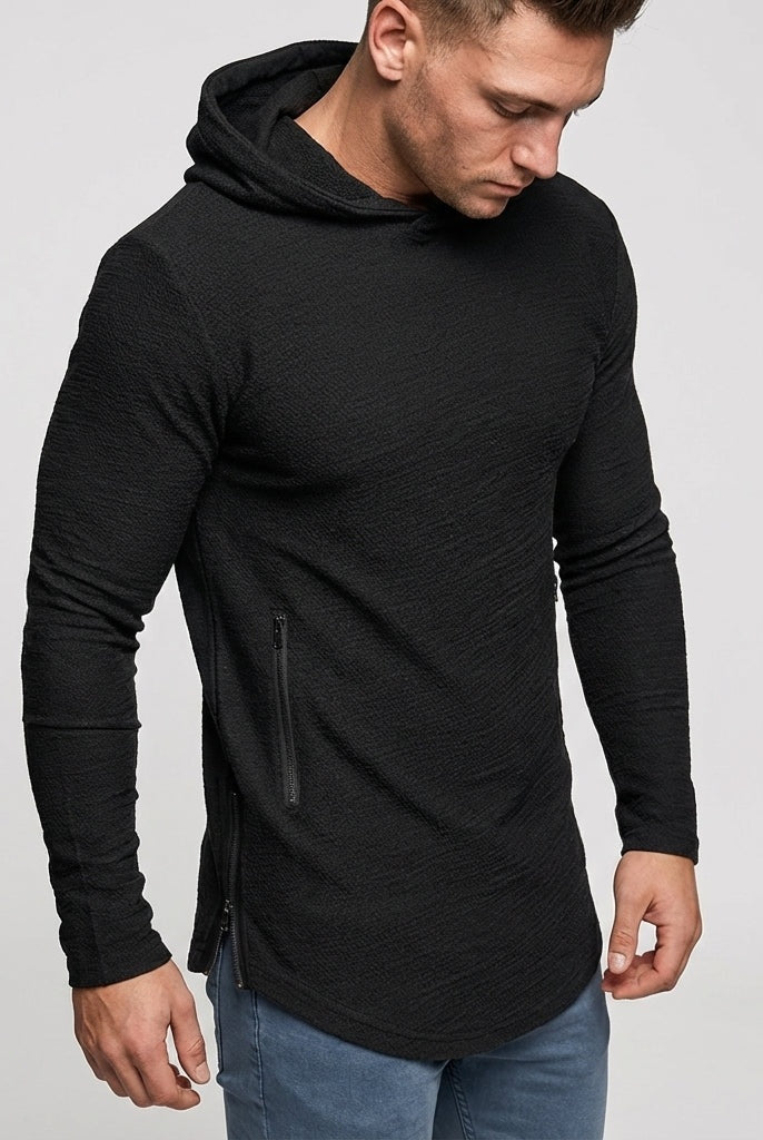 Men's slim-fit gym hoodie in black, worn, with the zipped side pocket in view