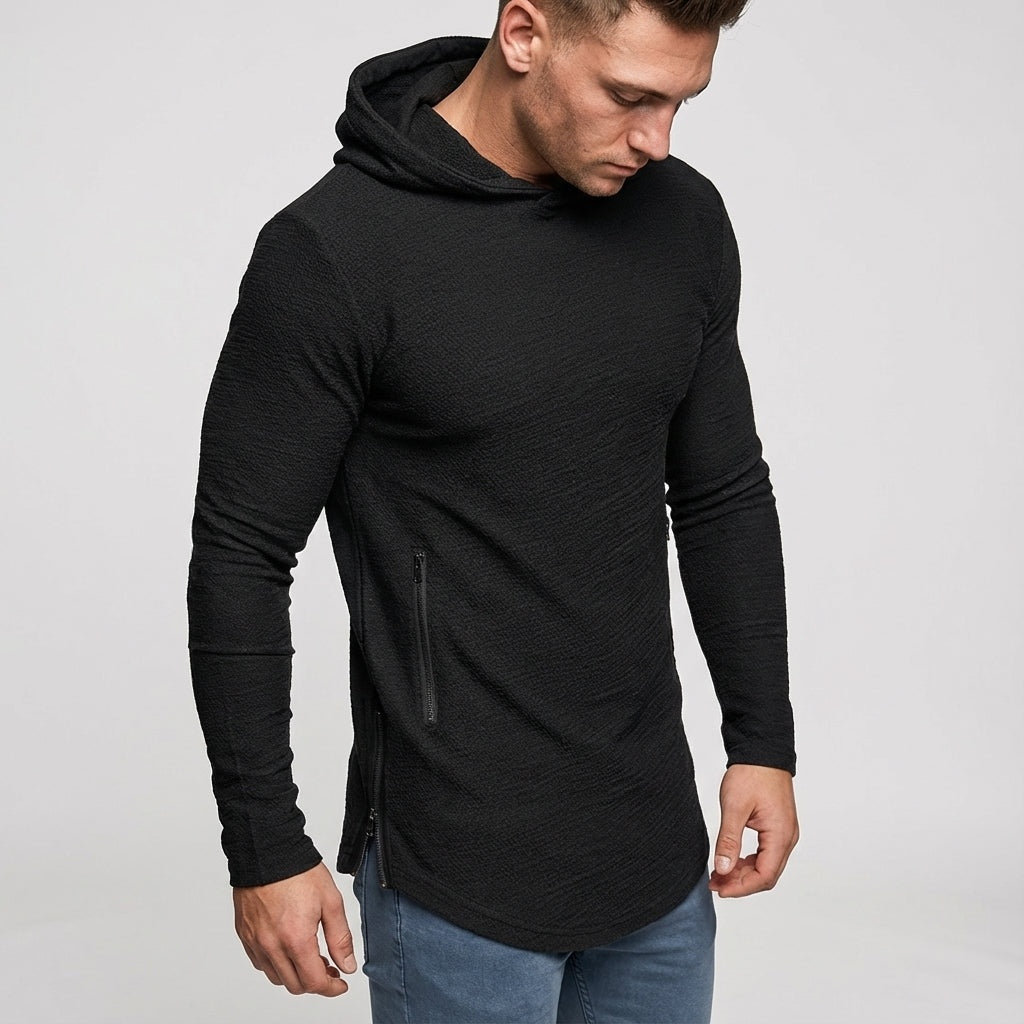 Men's slim-fit gym hoodie in black, worn, with the zipped side pocket in view