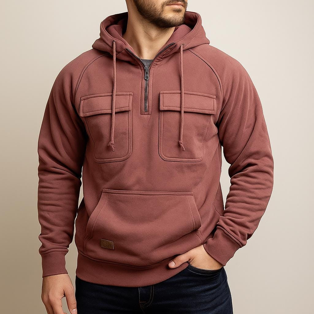Men's half-zip utility hoodie with chest pockets in dusty pink, worn, front view
