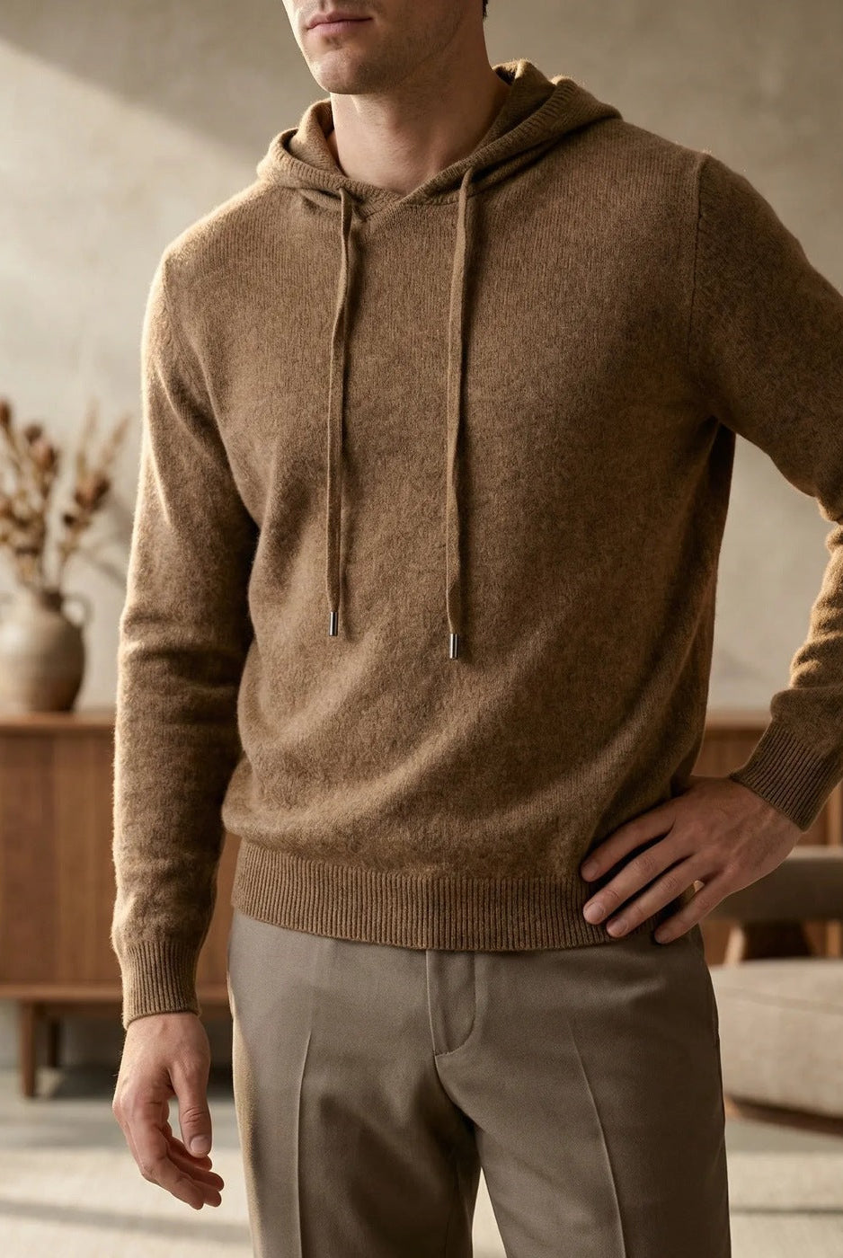 Men's fine-knit hooded jumper in brown, worn in a living room