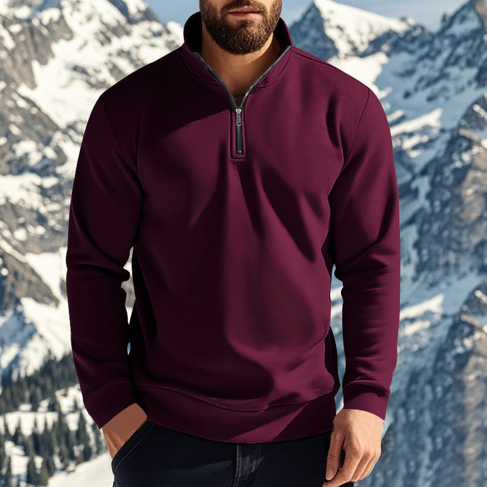 Man wearing a wine red quarter zip jumper in front of snow-capped peaks | Chaps London