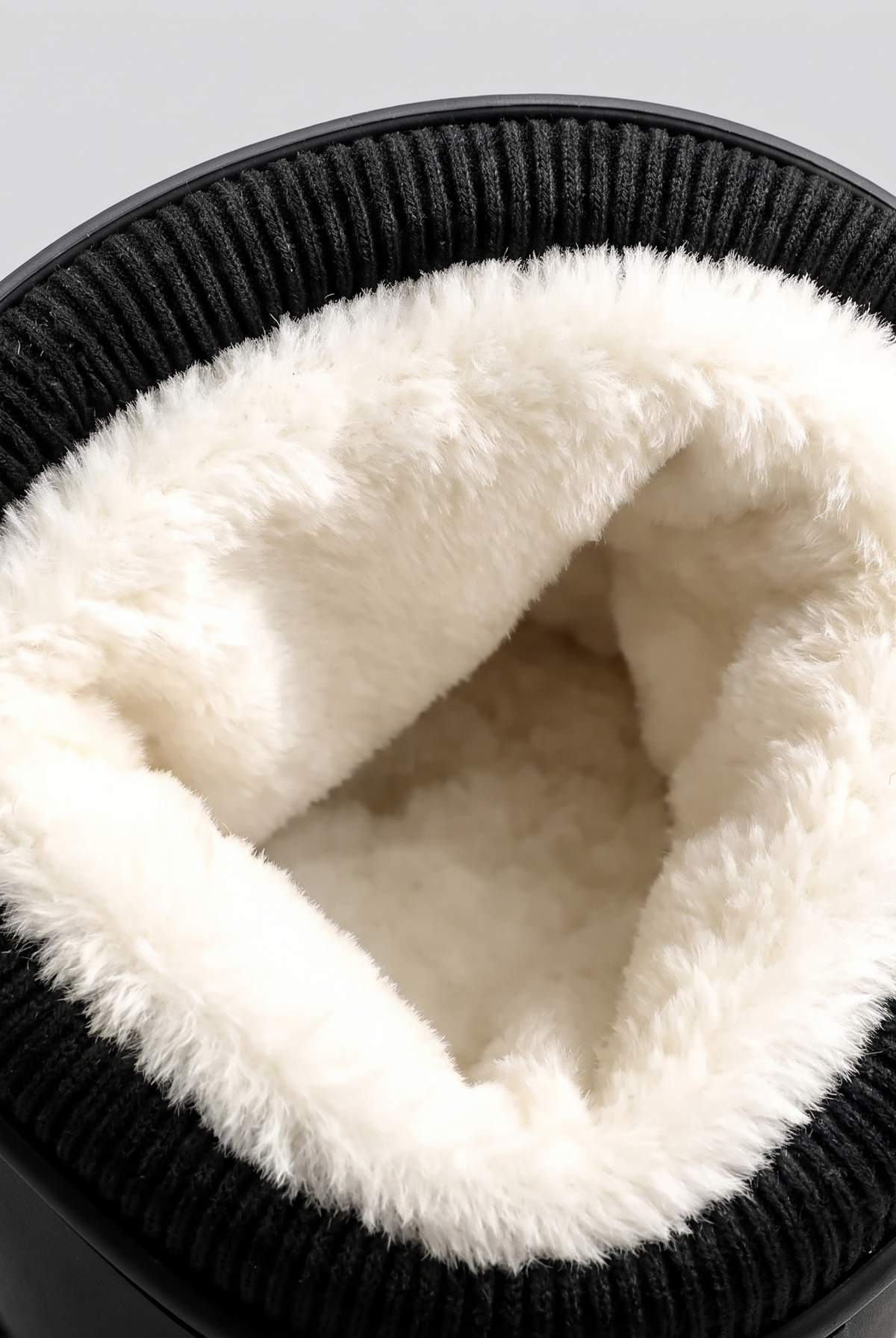 Close-up of the white fleece lining inside the ribbed knit cuff.