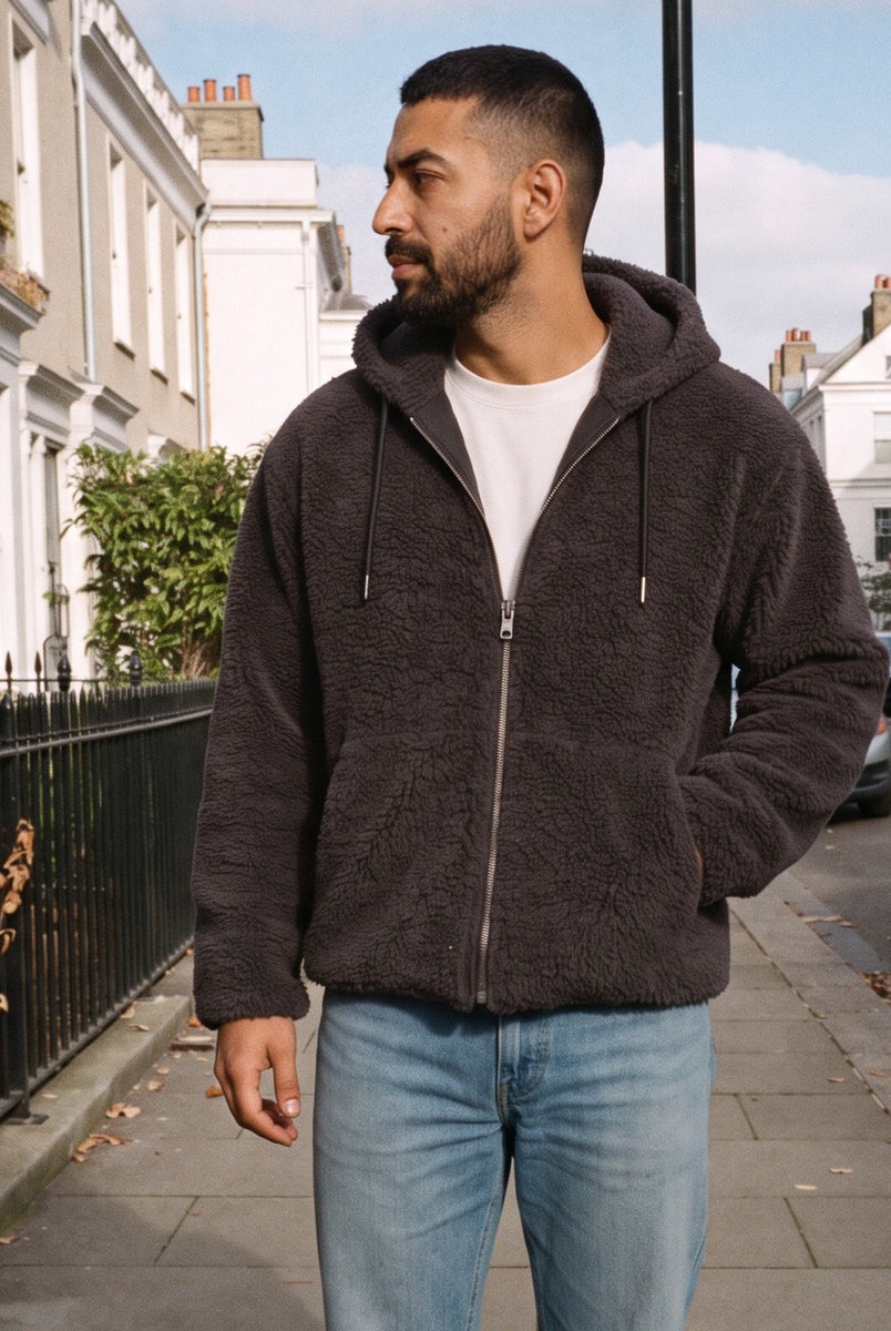 Men's hooded borg jacket in dark grey, worn by a model on a street
