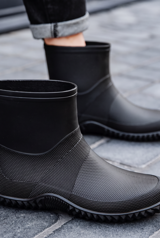 Black rubber ankle boots for men, worn on the street