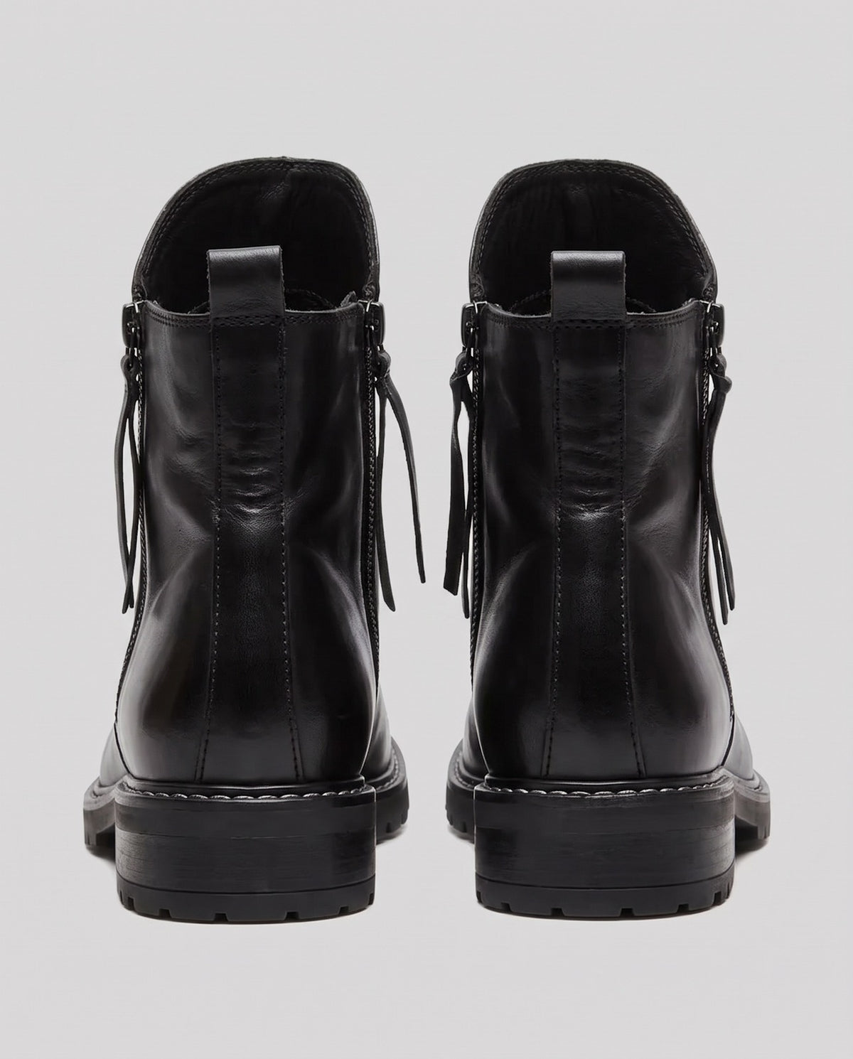 Black leather ankle boots with side zippers, rear view, lug sole | Chaps London