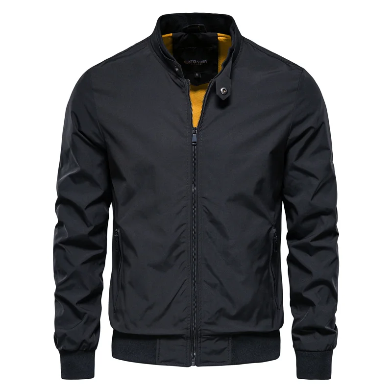 Black zip-up bomber jacket with yellow lining, worn by man, front view | Chaps London