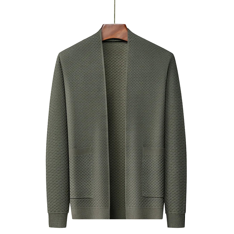 Olive green knitted open-front cardigan with textured pattern, hanging on wooden hanger | Chaps London