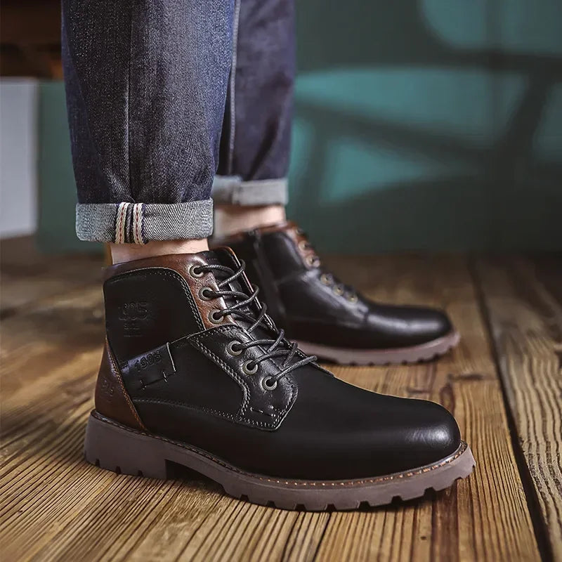 Black and brown lace-up ankle boot worn by person on wooden floor | Chaps London