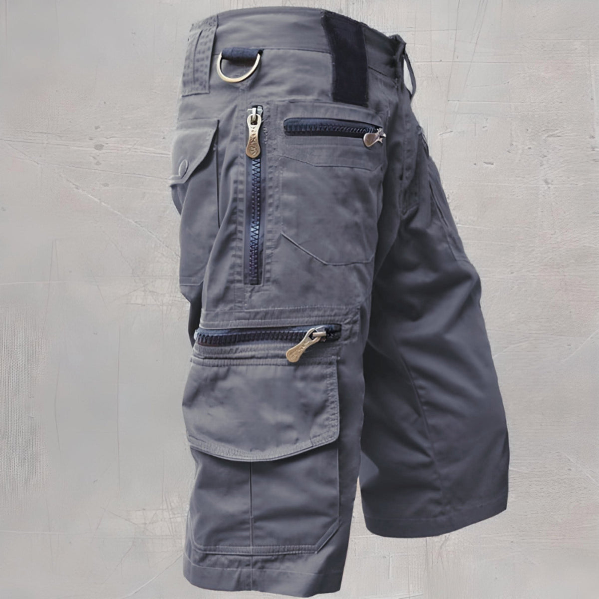 Gray cargo shorts with multiple zippered pockets, shown flat on display | Chaps London