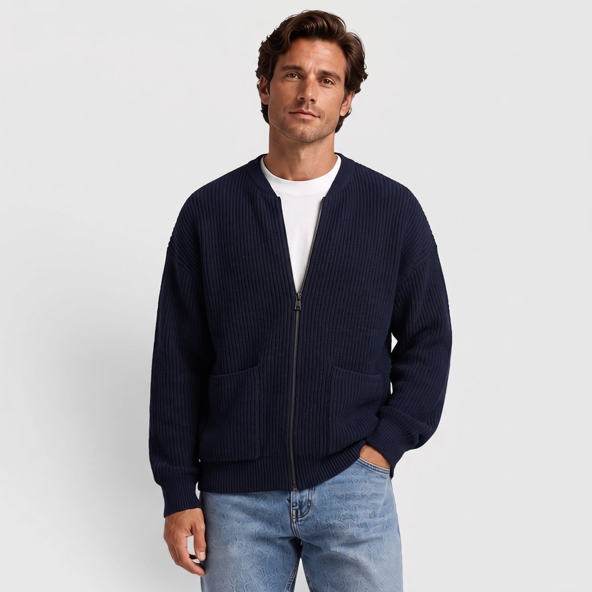 Man wearing a navy oversized chunky rib knit zip cardigan with patch pockets over a white T-shirt | Chaps London