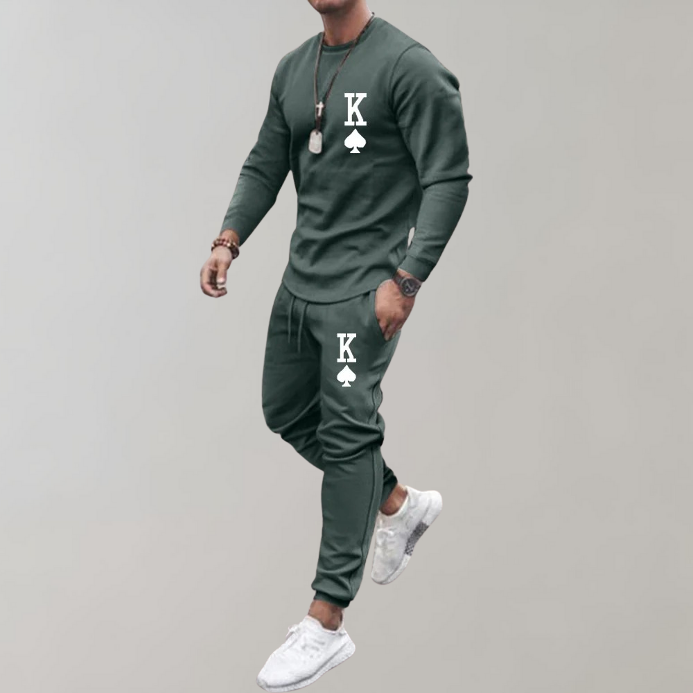 Man wearing green sweatshirt and jogger pants with printed card design | Chaps London