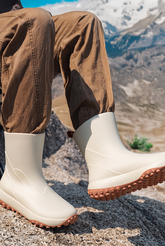 Beige men's wellies worn in the mountains
