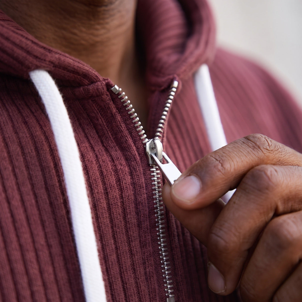 Maroon ribbed half-zip hoodie with white drawcords, worn by person, close-up | Chaps London