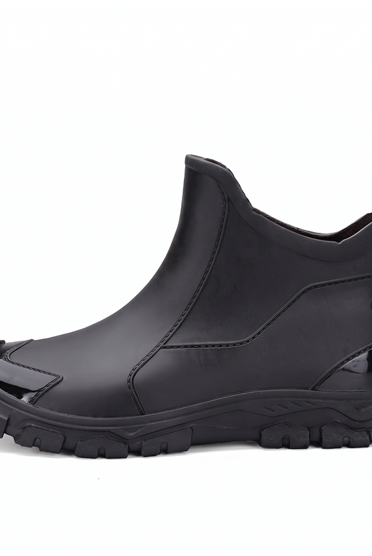 A black rubber ankle boot shown from the side against a white background.