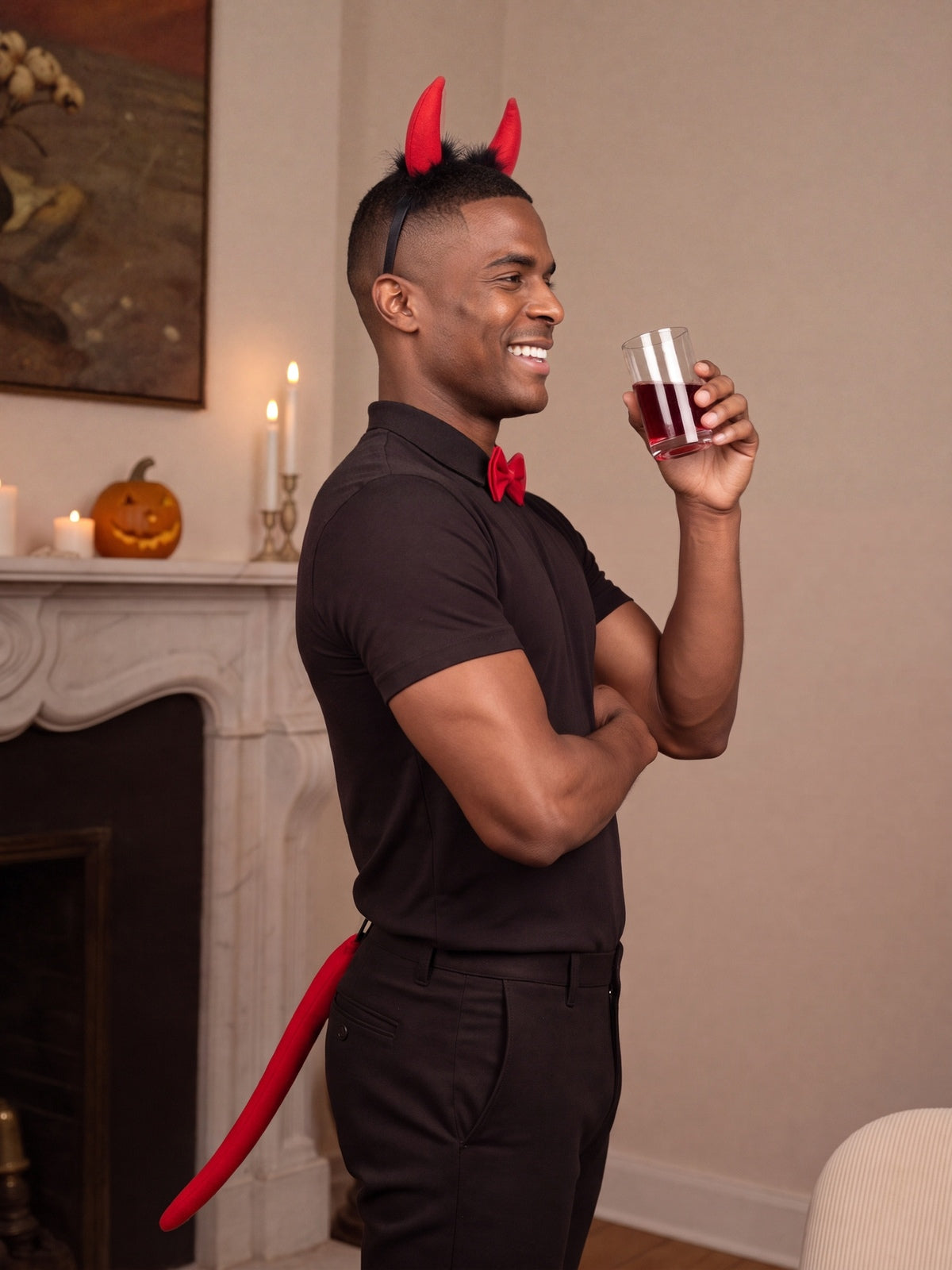 Model in the devil set raising a glass at a Halloween party