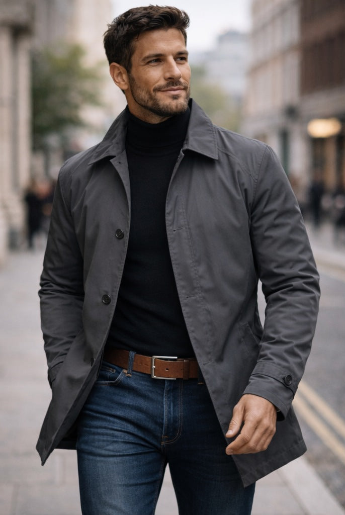 Man wearing gray rain mac jacket over black turtleneck and jeans | Chaps London