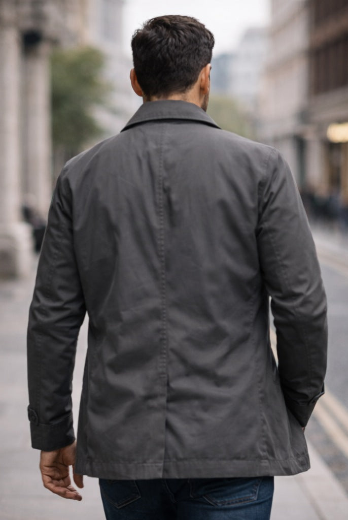 Man wearing gray button-front rain mac walking on city street | Chaps London
