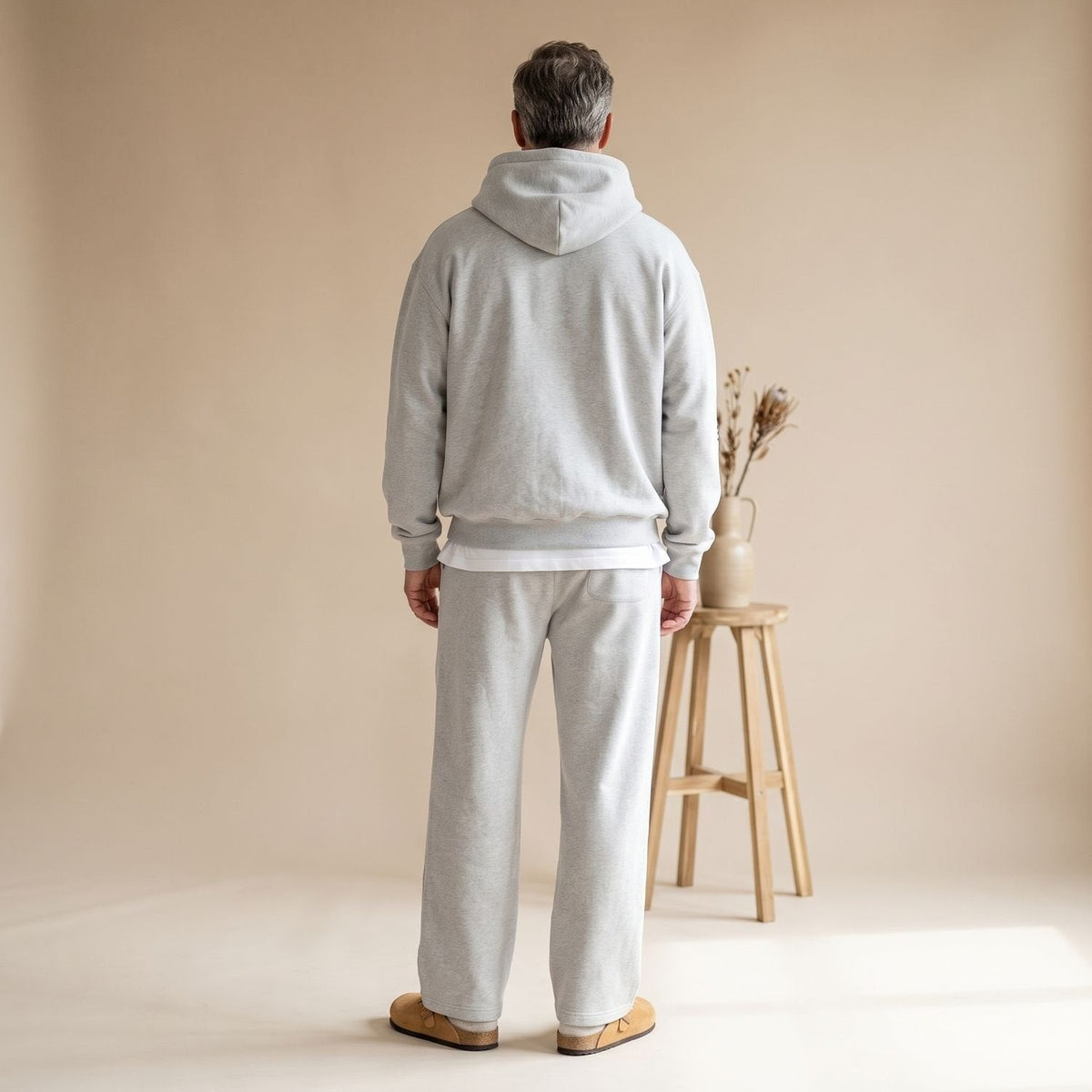 Man wearing light grey hooded tracksuit with straight leg joggers, rear view | Chaps London