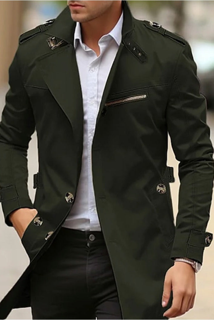 Man wearing dark green trench coat with epaulettes, standing outdoors on sidewalk | Chaps London