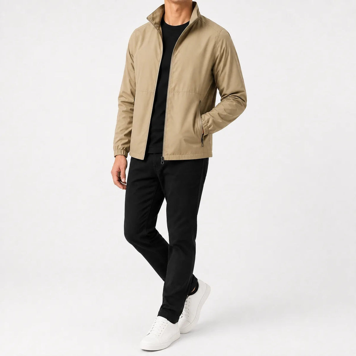 Man wearing beige zip-up jacket, black t-shirt, black pants, white sneakers | Chaps London