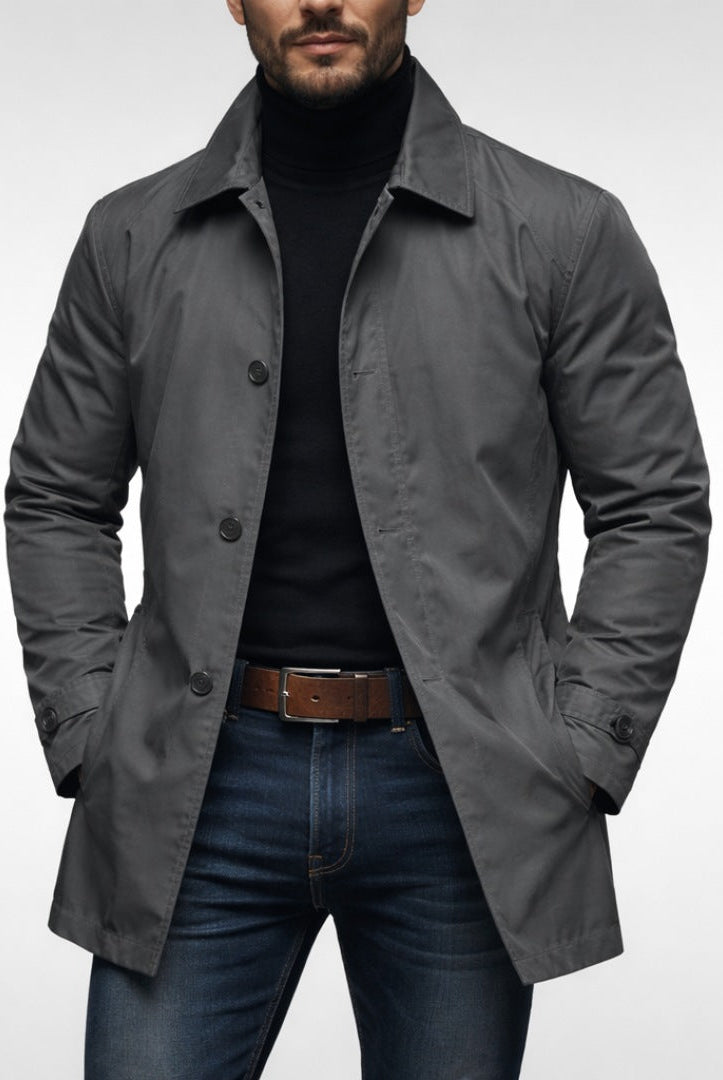 Man wearing gray button-front mac coat over black turtleneck and jeans | Chaps London