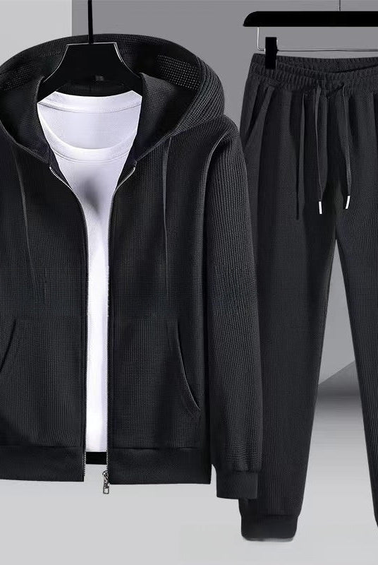 Black waffle-textured zip hoodie and matching jogger pants, flat on hangers | Chaps London