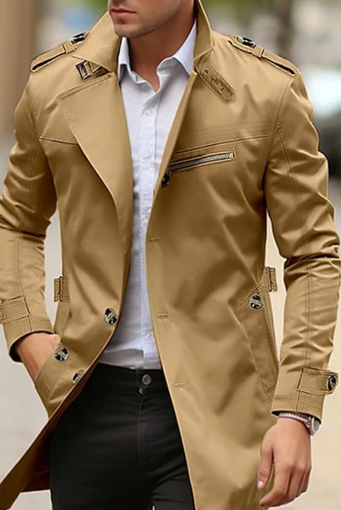 Man wearing khaki trench coat with epaulettes, buttoned front, worn outdoors | Chaps London