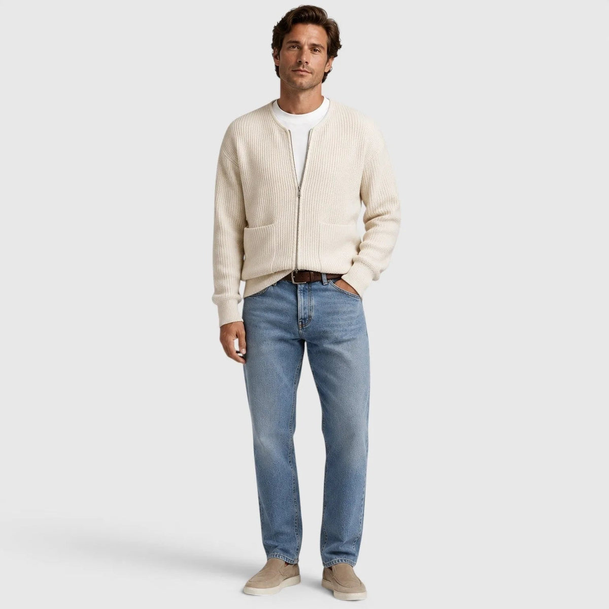 Man wearing cream zip cardigan, white t-shirt, and light blue jeans | Chaps London