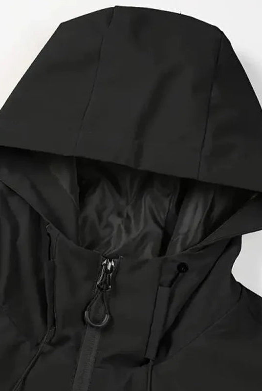 Black hooded rain jacket close-up showing zipper and drawstring details, worn by person | Chaps London