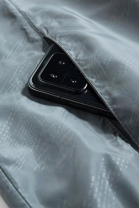 Gray windbreaker interior pocket with smartphone, subtle patterned lining fabric visible | Chaps London