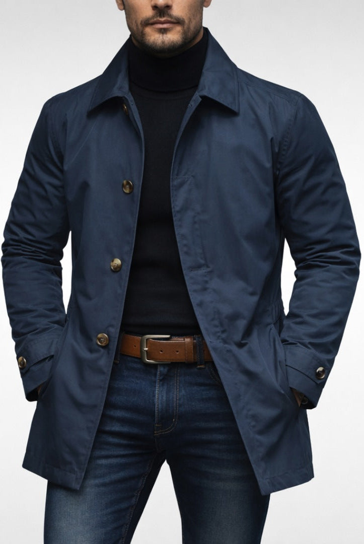 Man wearing navy blue button-front trench coat with black turtleneck and jeans | Chaps London