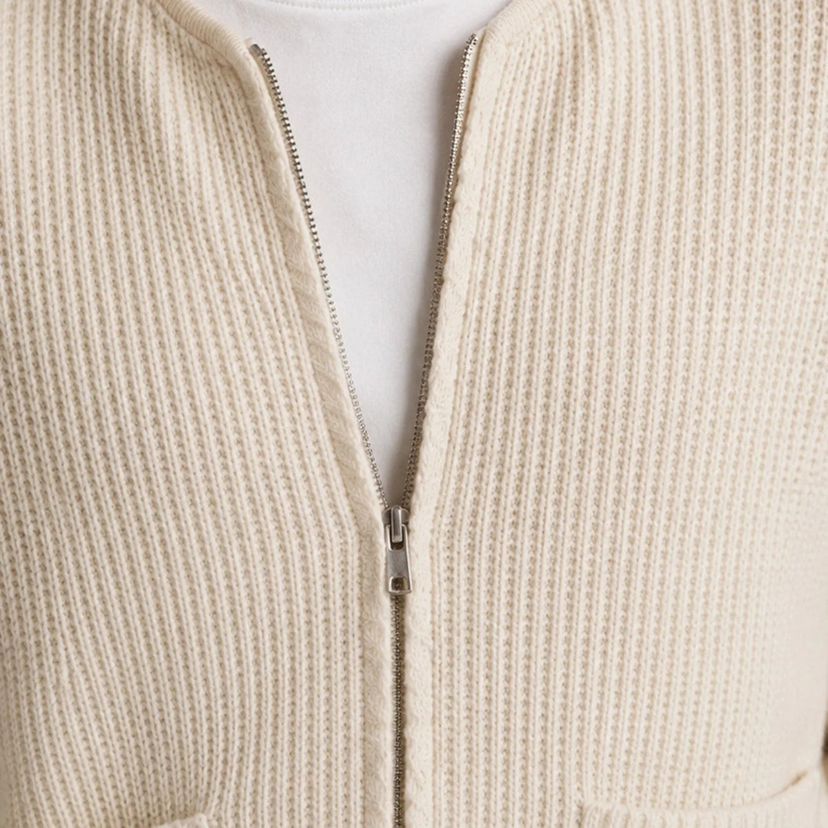 Cream ribbed knit zip cardigan close-up with silver zipper, worn by person | Chaps London
