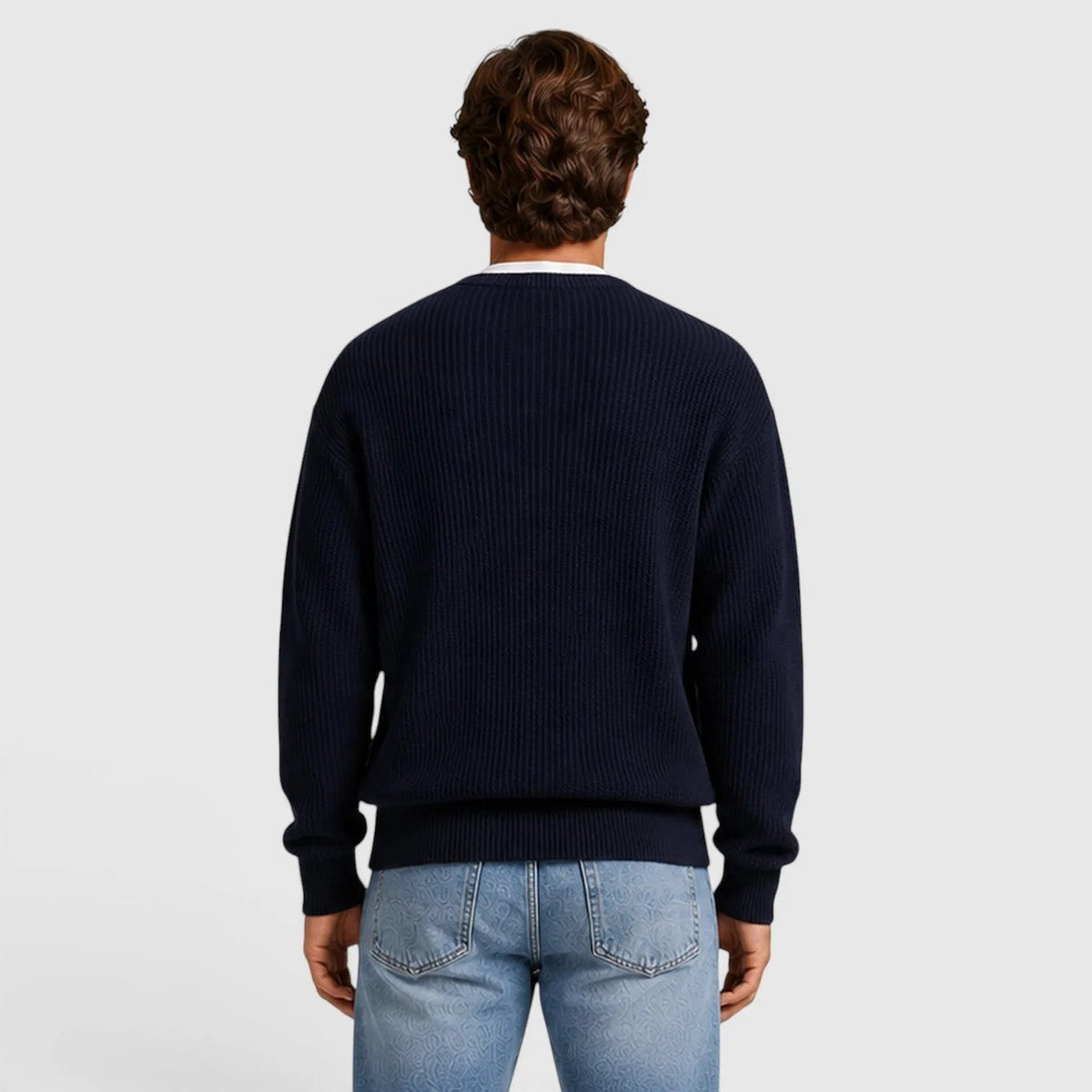 Man wearing navy ribbed knit sweater, back view, with light blue jeans | Chaps London