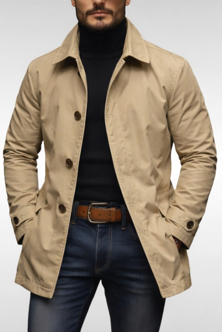 Man wearing beige button-front trench coat over black turtleneck and jeans | Chaps London