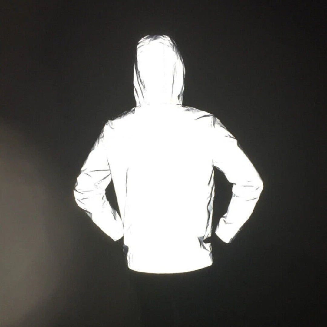 Man wearing reflective hooded jacket, back view, glowing white in darkness | Chaps London