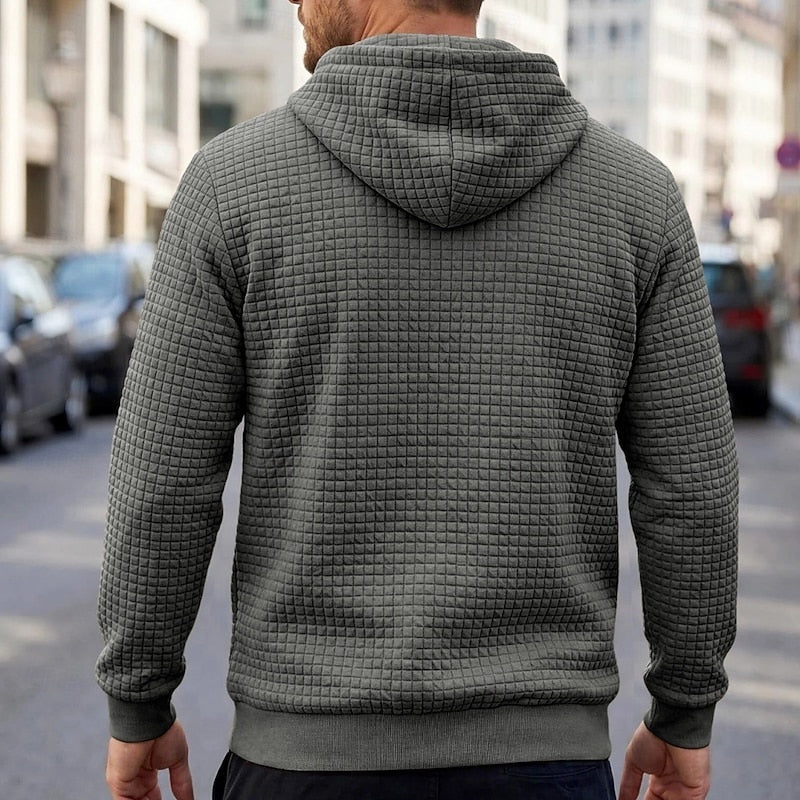 Man wearing grey quilted texture hoodie, back view, walking outdoors on street | Chaps London