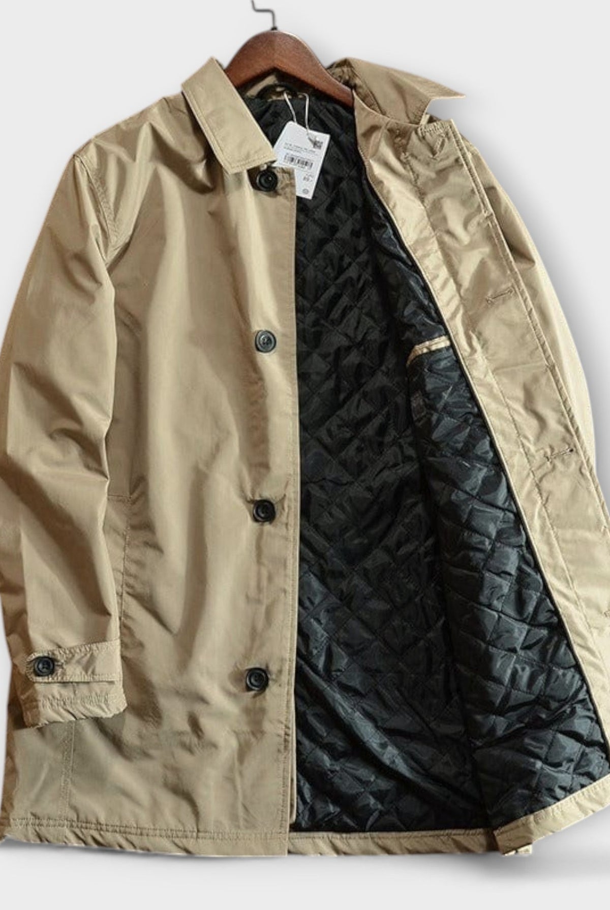 Beige cotton rain mac coat on hanger, quilted black lining visible | Chaps London