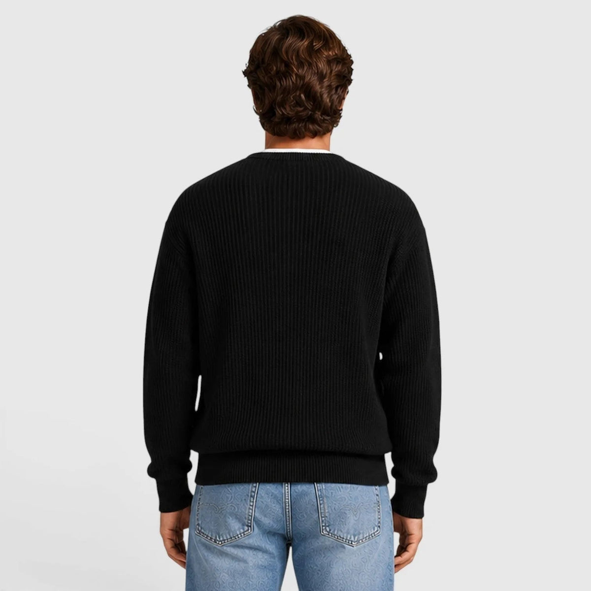 Man wearing black ribbed knit crewneck sweater, rear view, with blue jeans | Chaps London