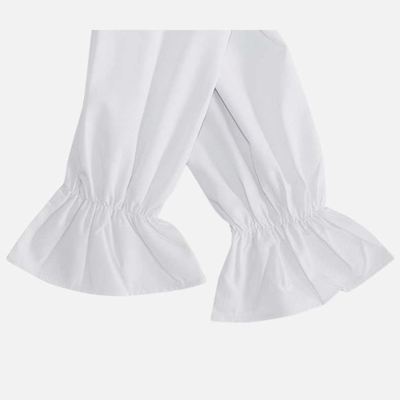 White ruffled cuffs on pants sleeves, worn, close-up view | Chaps London