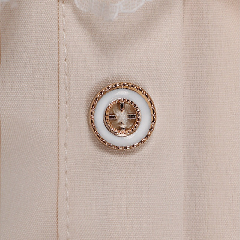 Close-up of beige shirt with ornate gold and white decorative button | Chaps London