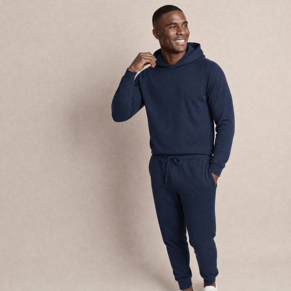 Man wearing navy raglan hoodie and matching joggers, standing casually | Chaps London