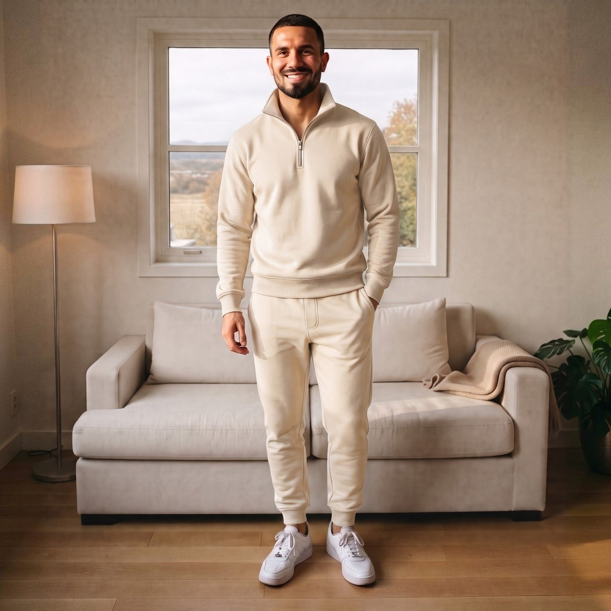 Man wearing cream half zip tracksuit with joggers in living room | Chaps London