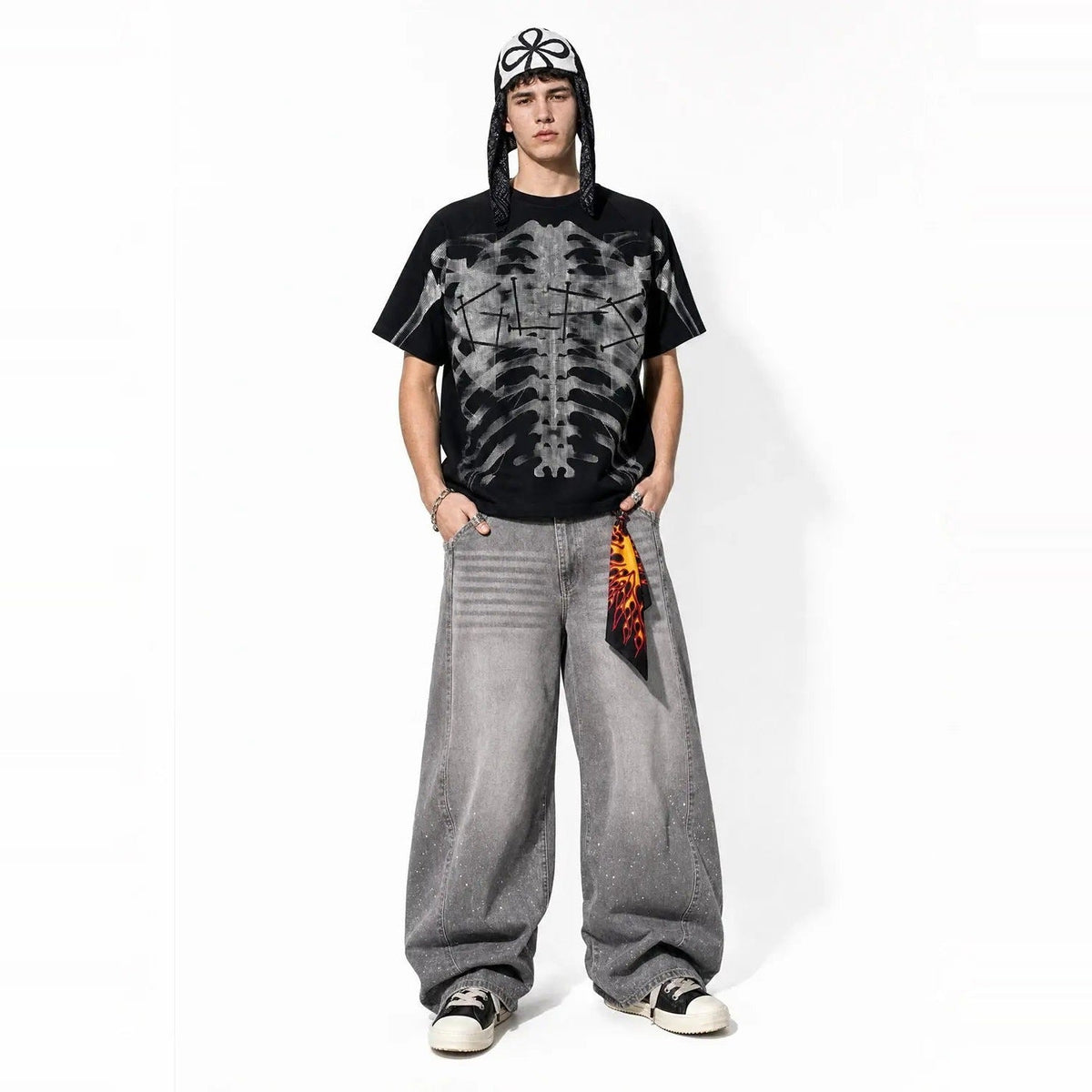 Man wearing black oversized T-shirt with gray ribcage print, baggy jeans | Chaps London