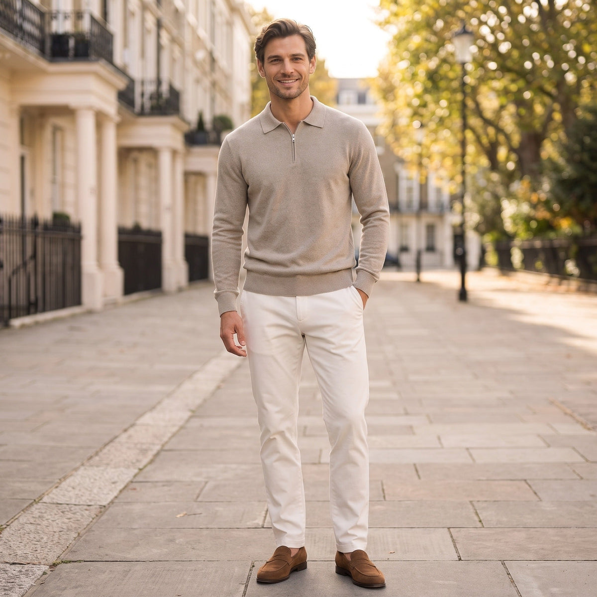 Man wearing beige quarter zip knit jumper with white trousers outdoors | Chaps London