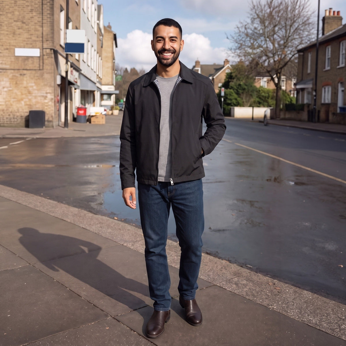 Man wearing black waterproof jacket with jeans standing on wet street | Chaps London